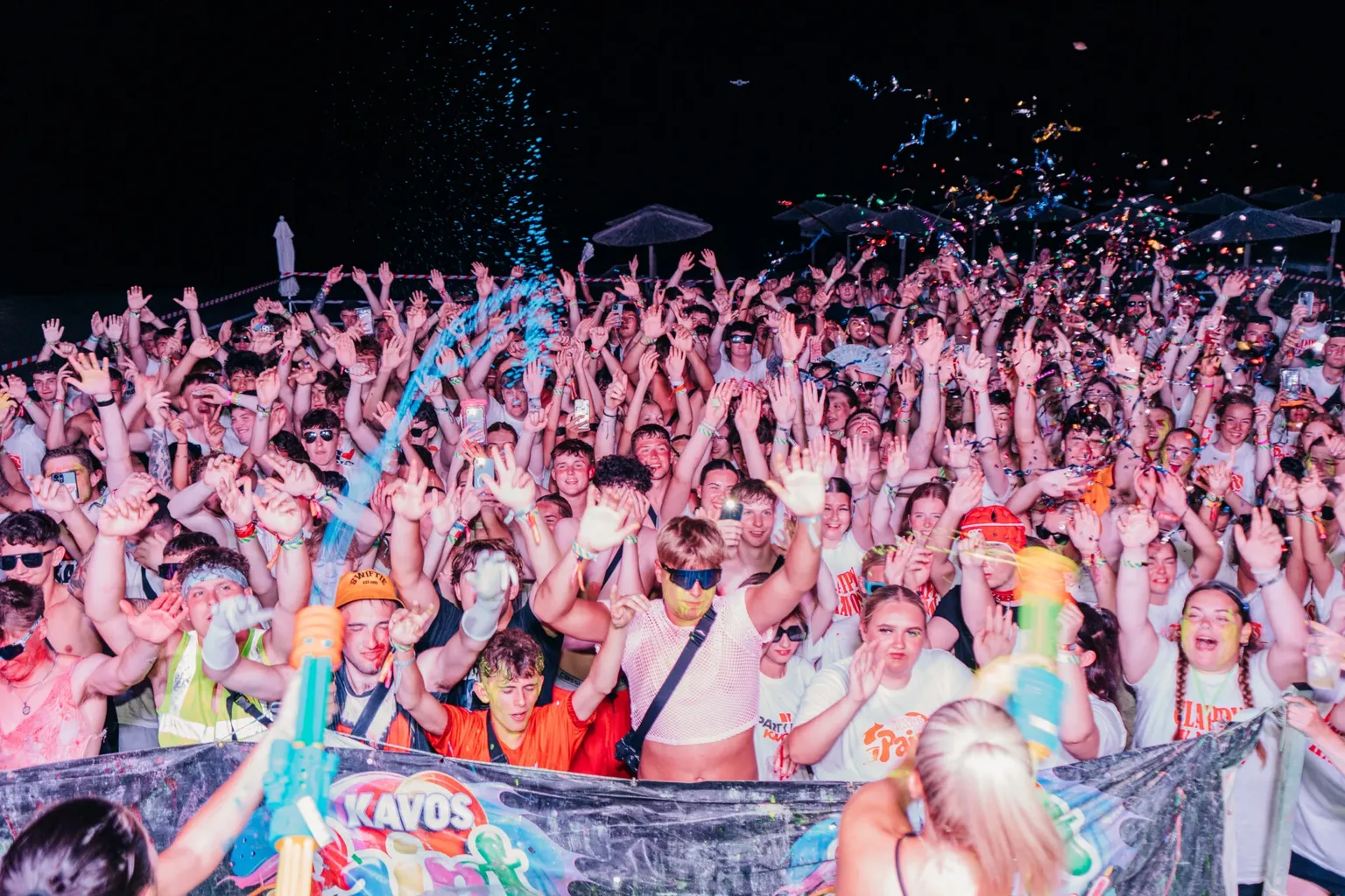 Crowd covered in UV paint at the Kavos Paint Party