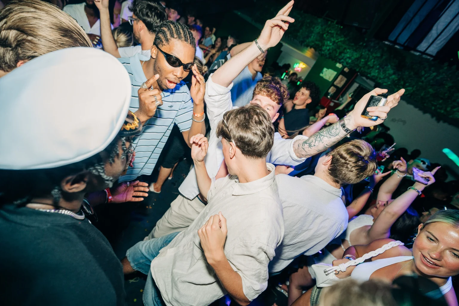 Crowd bringing the heat at Club Tropicana Albufeira, dancing hard and living it up under the neon lights all night long.