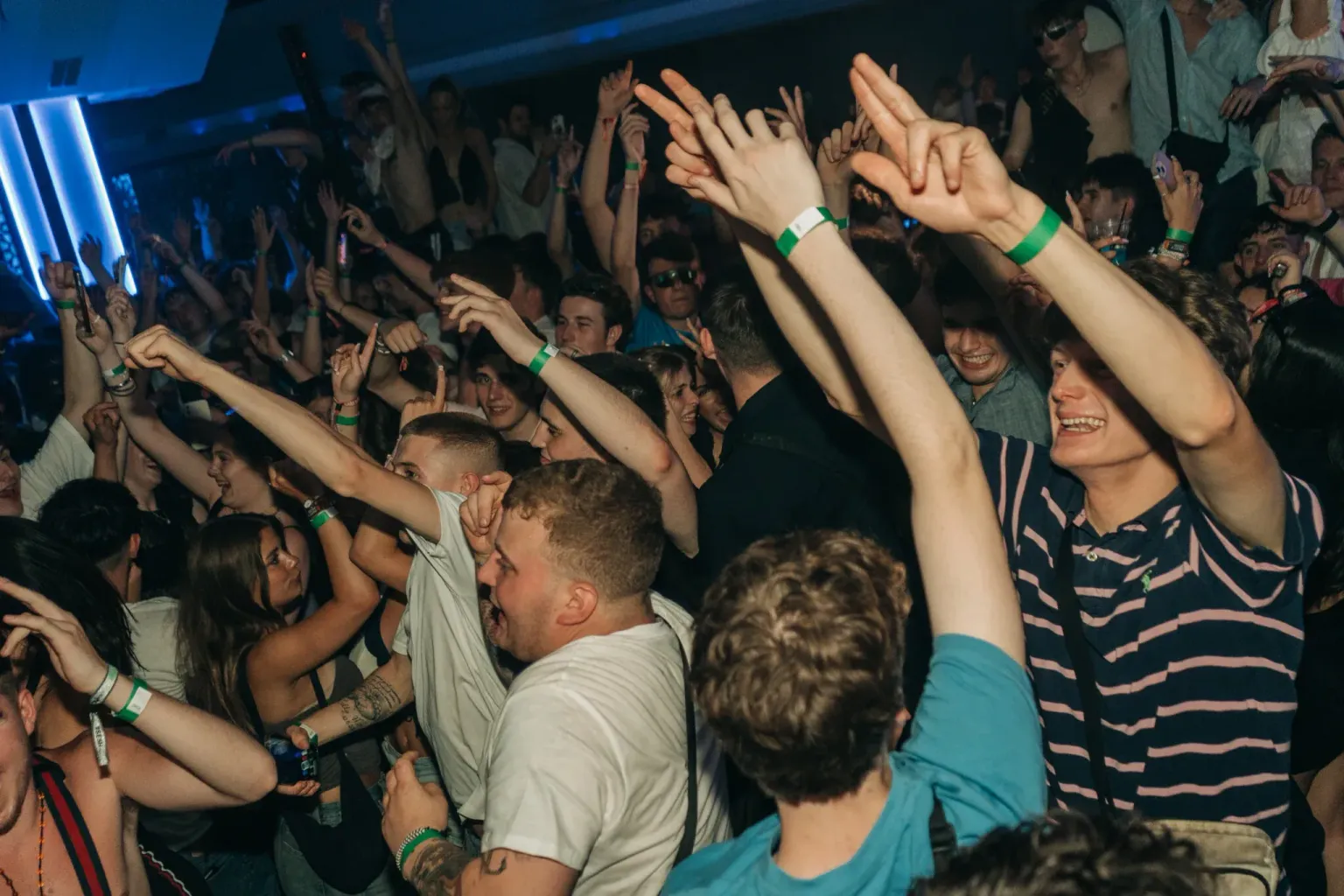 Clubbers dancing beneath blue lighting at House of Tech in Kavos