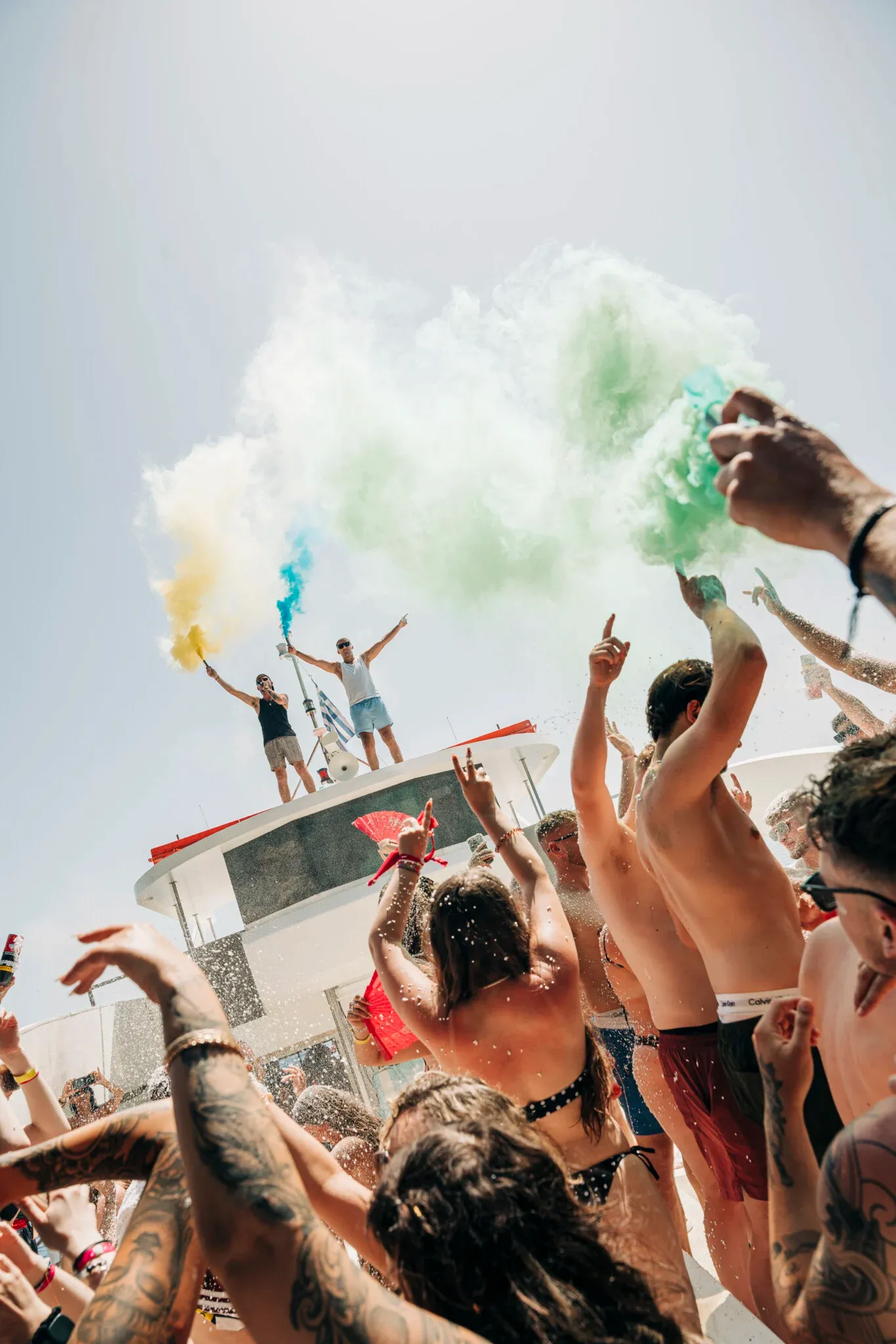 Lads and girls party hard on the Kavos Booze Cruise as coloured smoke fills the sky and the deck erupts
