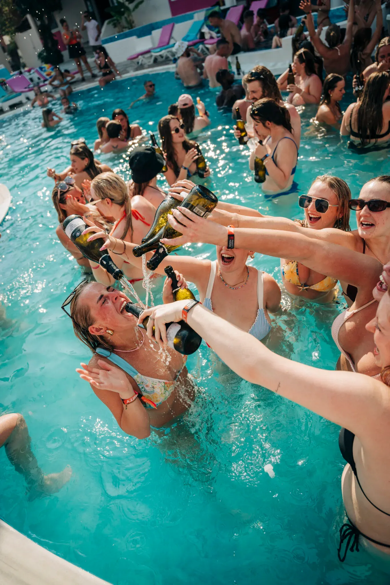 Girls pour champagne into their mate’s mouth as the packed pool erupts at Champagne Sessions Kavos, pure daytime chaos