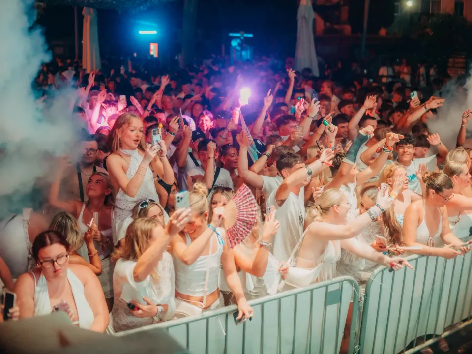 Crowd watching a live performer Bad Boy Chiller Crew at the packed Agenda White Party in Ayia Napa during a summer night event