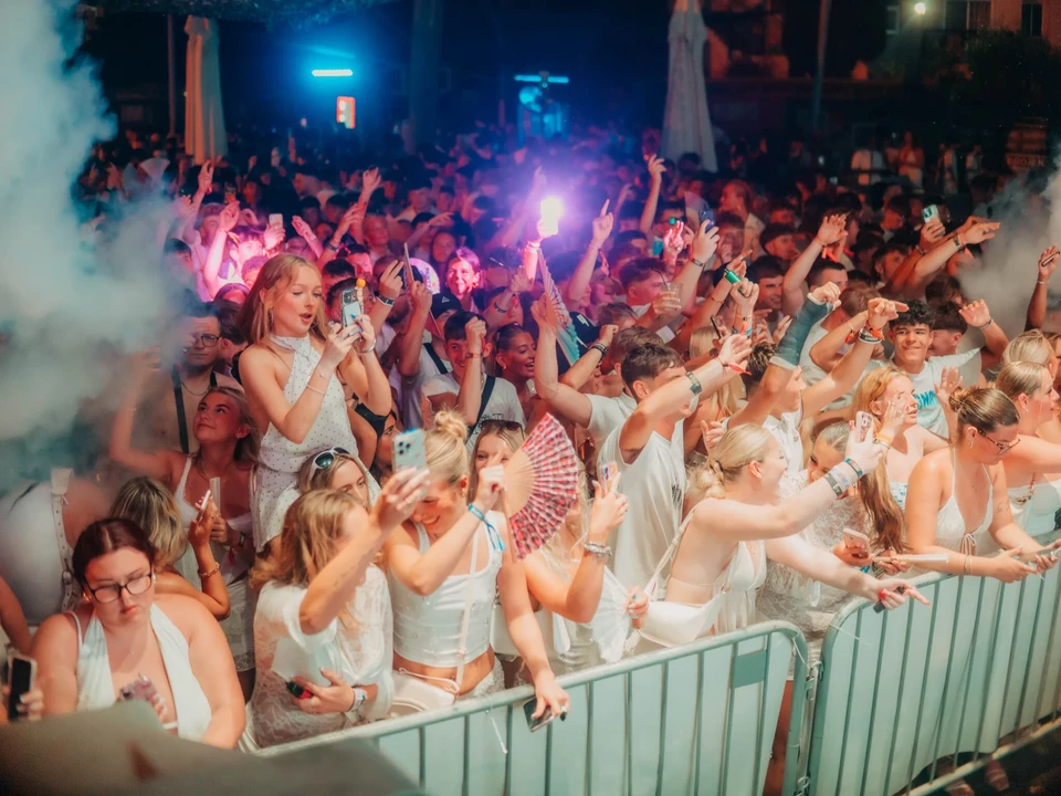 Crowd watching a live performer Bad Boy Chiller Crew at the packed Agenda White Party in Ayia Napa during a summer night event
