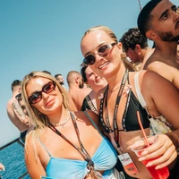 Two female Party Hard Travel Reps smiling on Boat Party