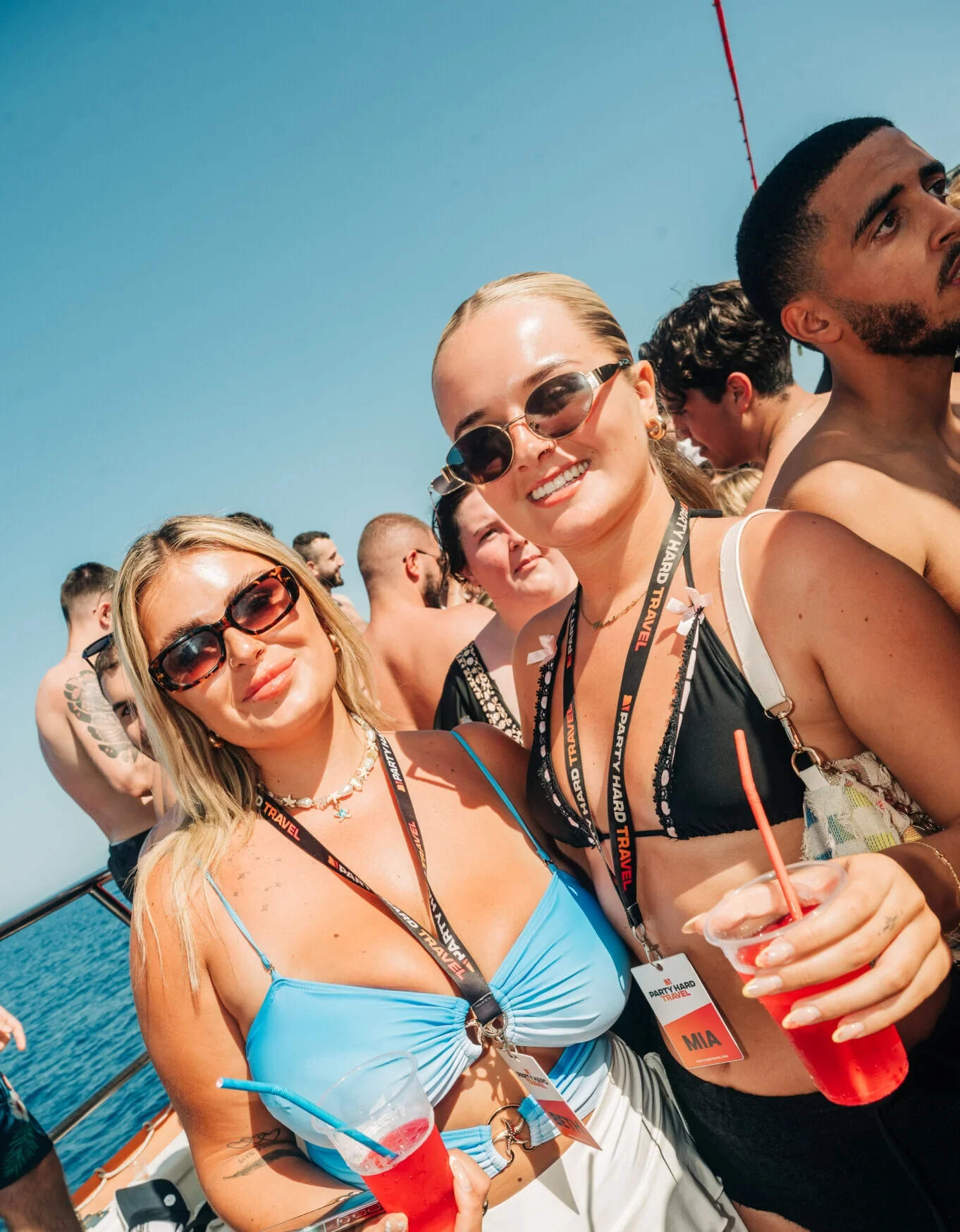 Two female Party Hard Travel Reps smiling on Boat Party