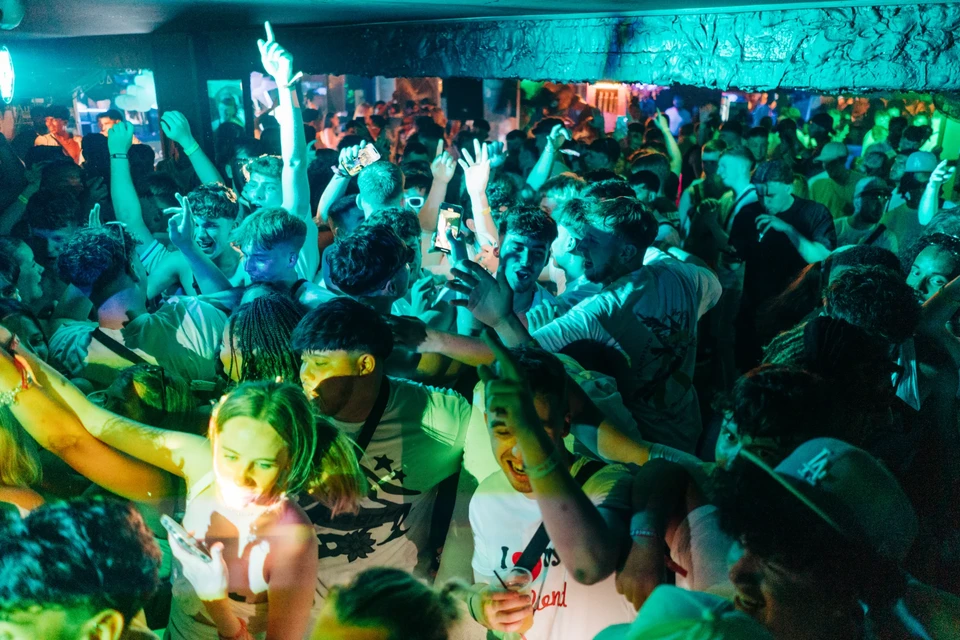 Packed crowd partying at the After Party Pass Croatia event in Bacvice Club Split with phones up, drinks flowing and hands in the air