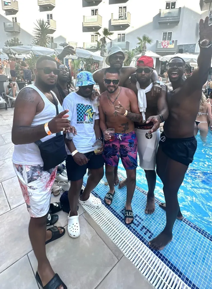 Group of lads posing at Bora Bora Malta pool party with drinks, DJ beats, sunshine and packed daytime party crowds