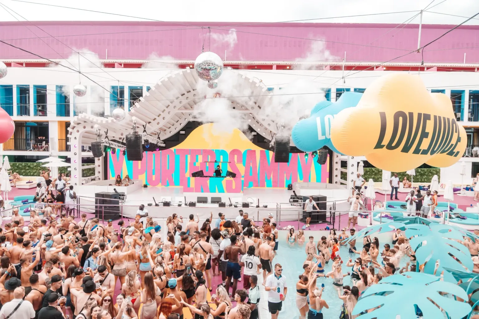 Crowd at a pool party beside the stage at Ibiza Rocks