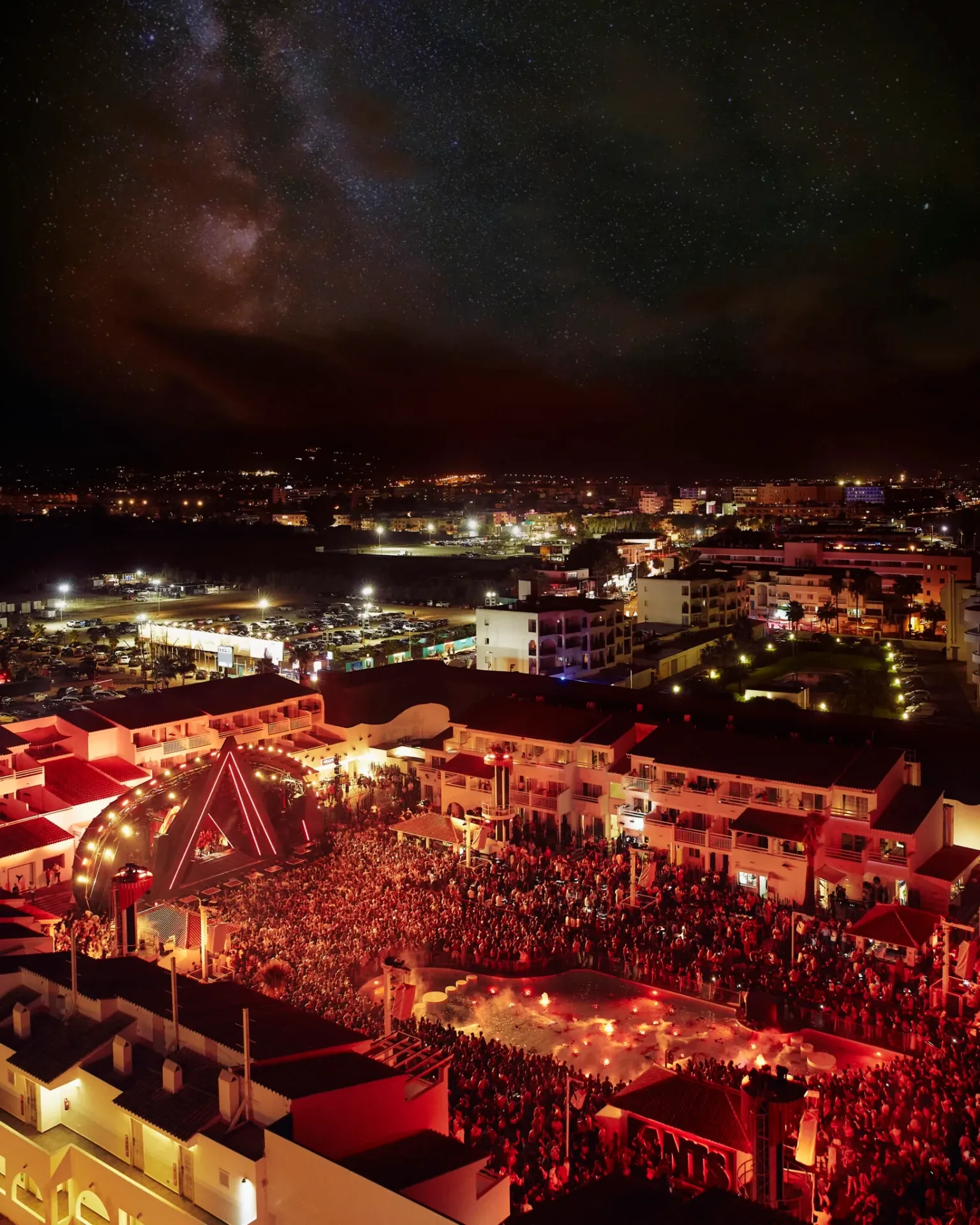 Crowd at ANTS at Ushuaïa Ibiza beneath the open-air stage and palm trees