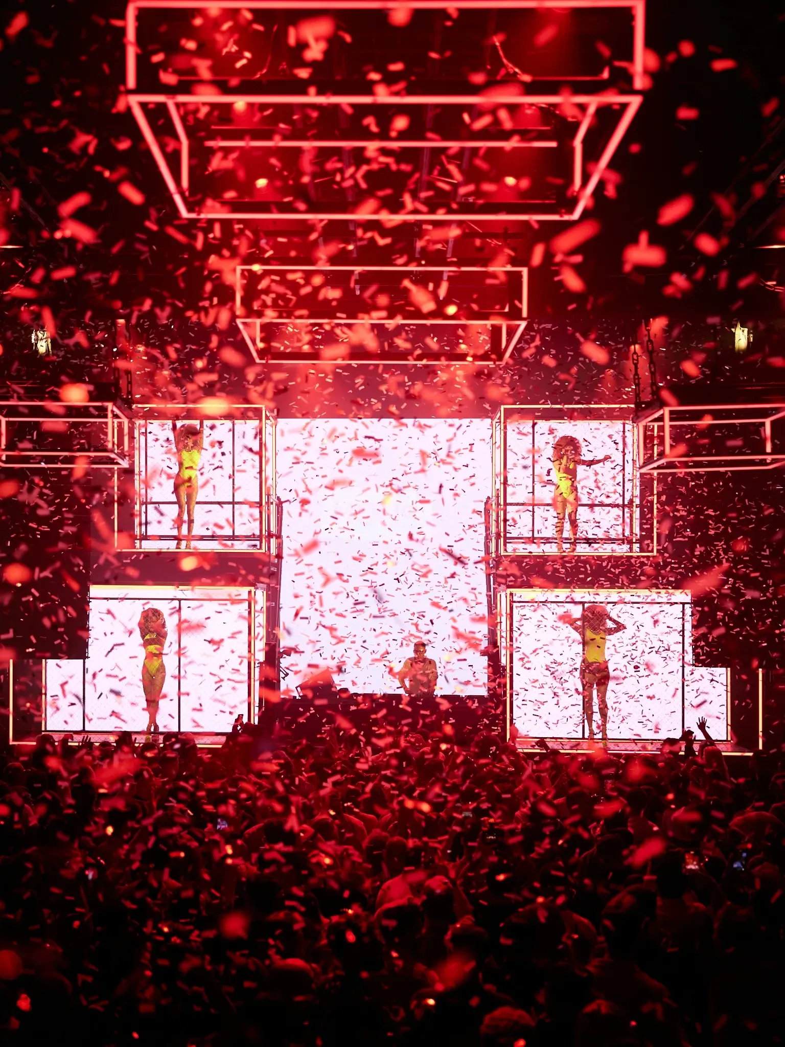 Clubbers at Glitterbox in Hï Ibiza beneath colourful lighting and stage production