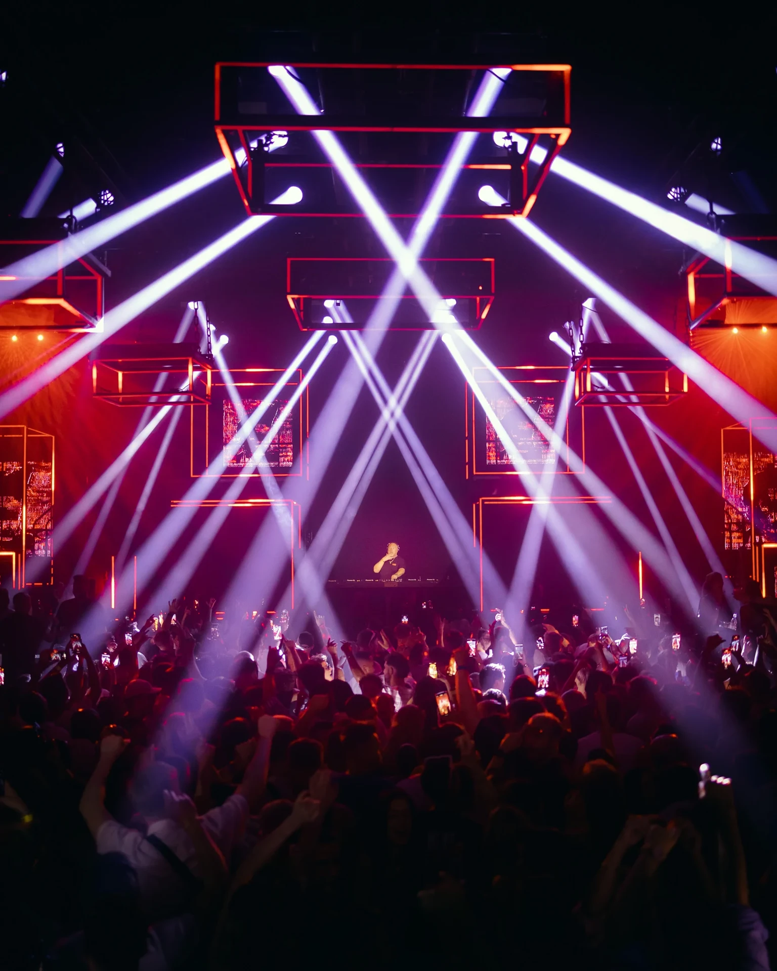 Clubbers at Glitterbox in Hï Ibiza beneath colourful lighting and stage production
