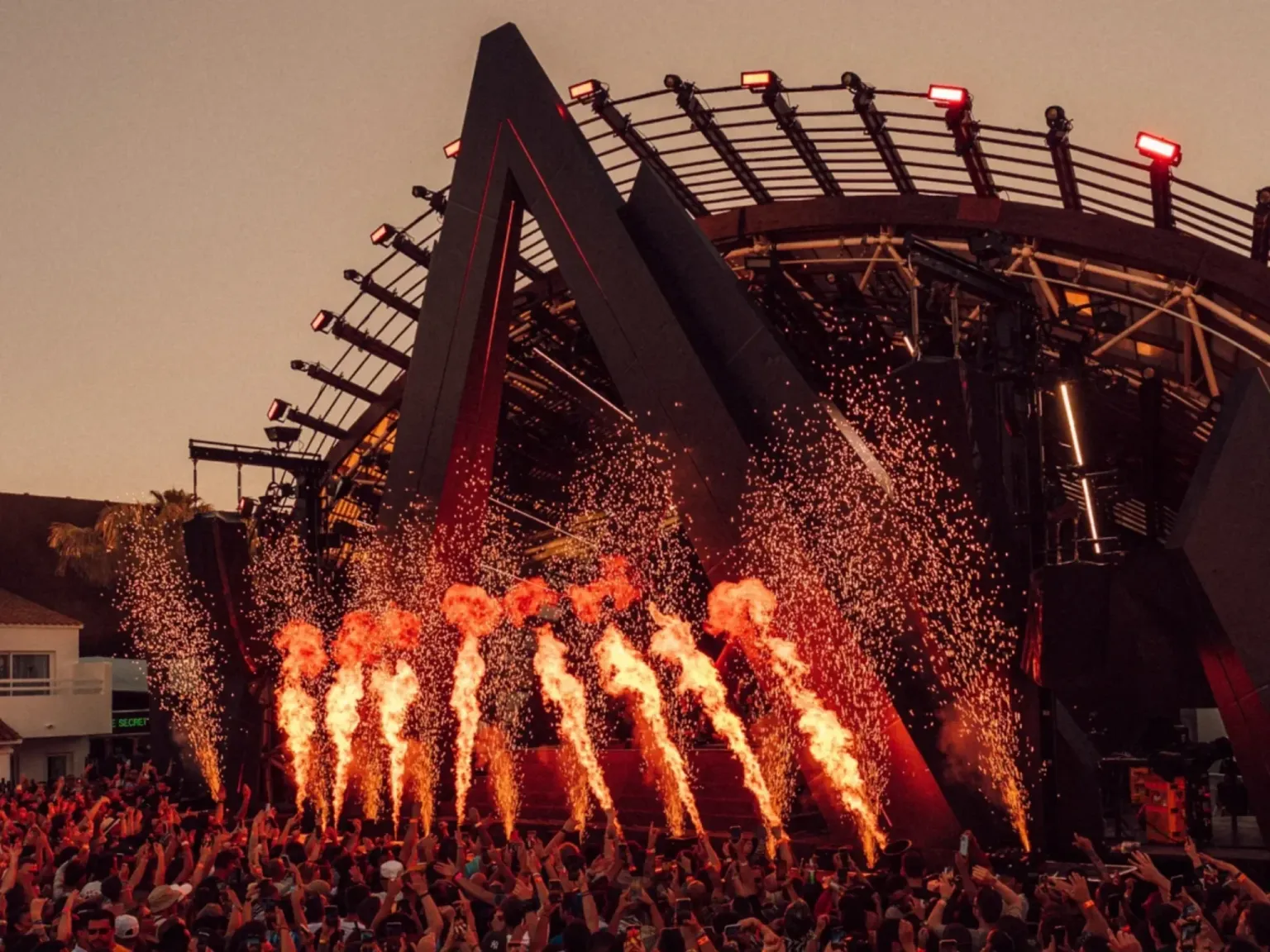 Ants Ibiza Ushuaia fir pyro hge crowds dancing at sunset with a large stage