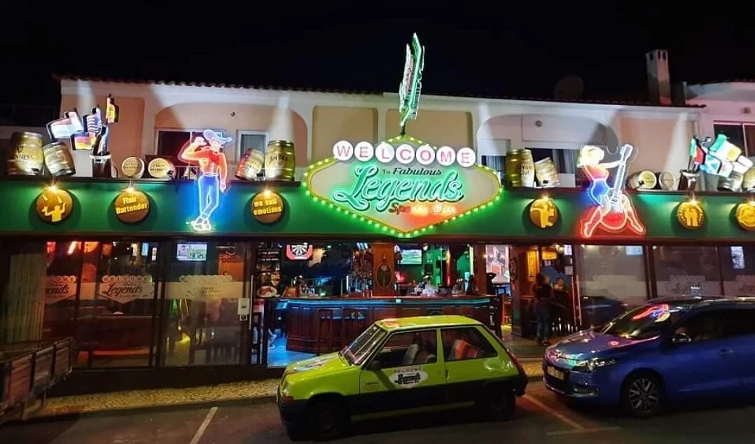 Legends Bar lighting up Albufeira’s Strip with neon signs, lively music and nonstop party vibes all night long.